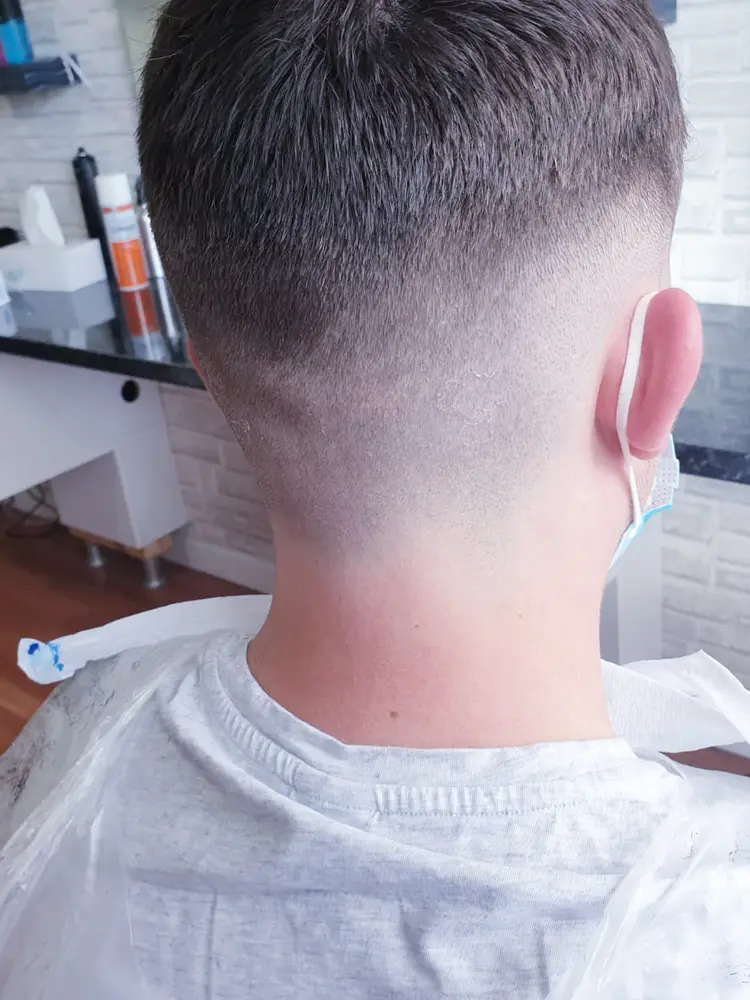 Back view of a tapered fade finished at the nape